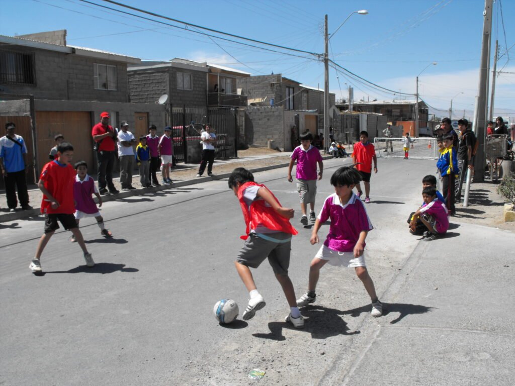 Kids playing street soccer