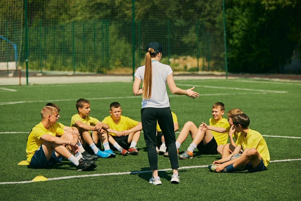 a coach speaking to players during training